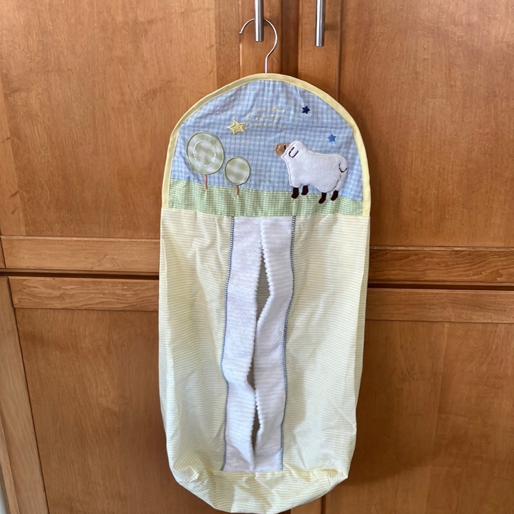 Diaper stacker with front loading compartment. Yellow/white striped w/ sheep